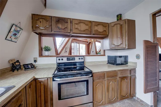a kitchen with stainless steel appliances granite countertop a stove a washer and dryer