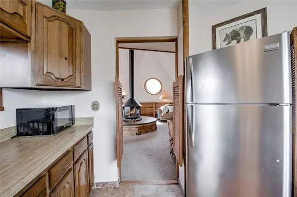 a kitchen with stainless steel appliances granite countertop a refrigerator and a stove