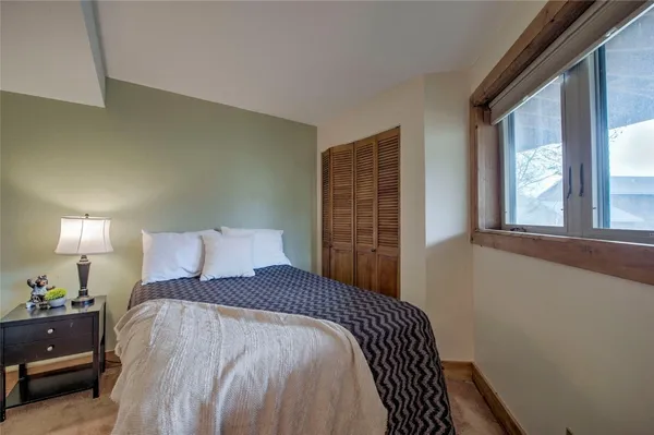 a bedroom with a bed and a window