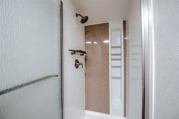 a bathroom with a shower and a sink
