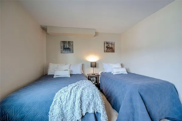 a bedroom with a bed and a lamp