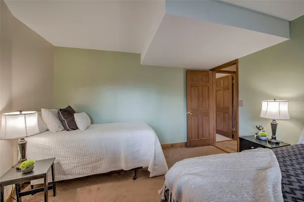 a bedroom with two beds and lamp