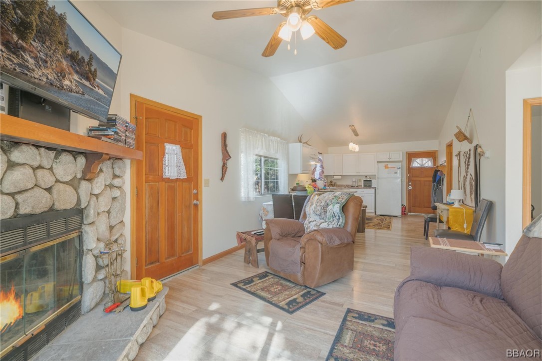 124 Riverside Avenue Sugarloaf, CA 92386 - Photo 11 of 22 a living room with furniture a fireplace and a chandelier