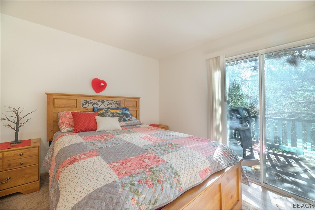 124 Riverside Avenue Sugarloaf, CA 92386 - Photo 12 of 22 a bedroom with a bed and a window