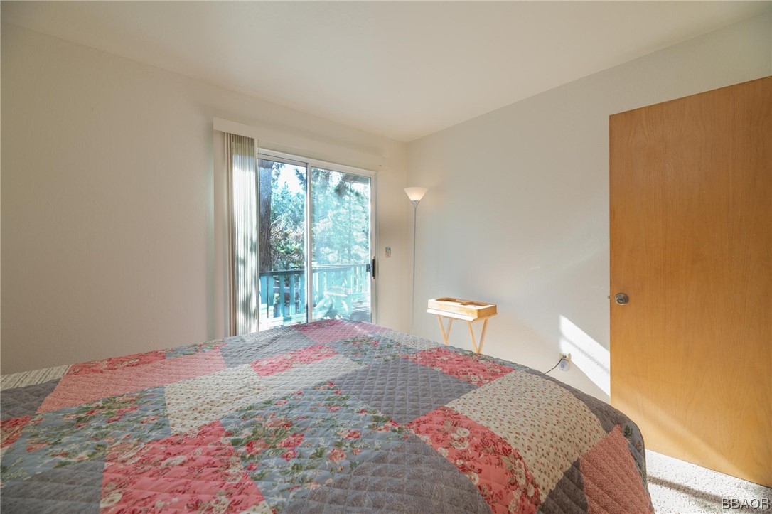 124 Riverside Avenue Sugarloaf, CA 92386 - Photo 13 of 22 a bedroom with a bed and a window