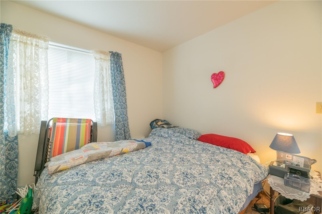 124 Riverside Avenue Sugarloaf, CA 92386 - Photo 16 of 22 a bedroom with a bed and a closet