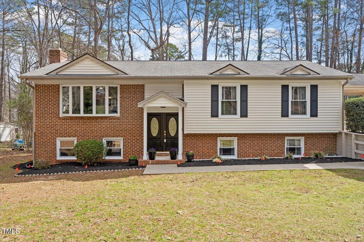 1203 Brookgreen Drive Cary, NC 27511 - Photo 1 of 46 a front view of a house with a yard