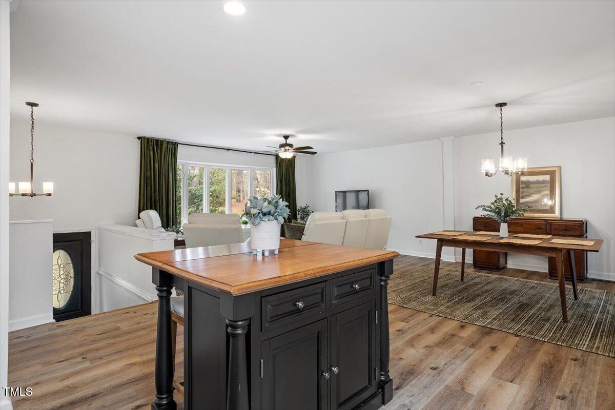 1203 Brookgreen Drive Cary, NC 27511 - Photo 14 of 46 a view of a kitchen area with furniture and wooden floor