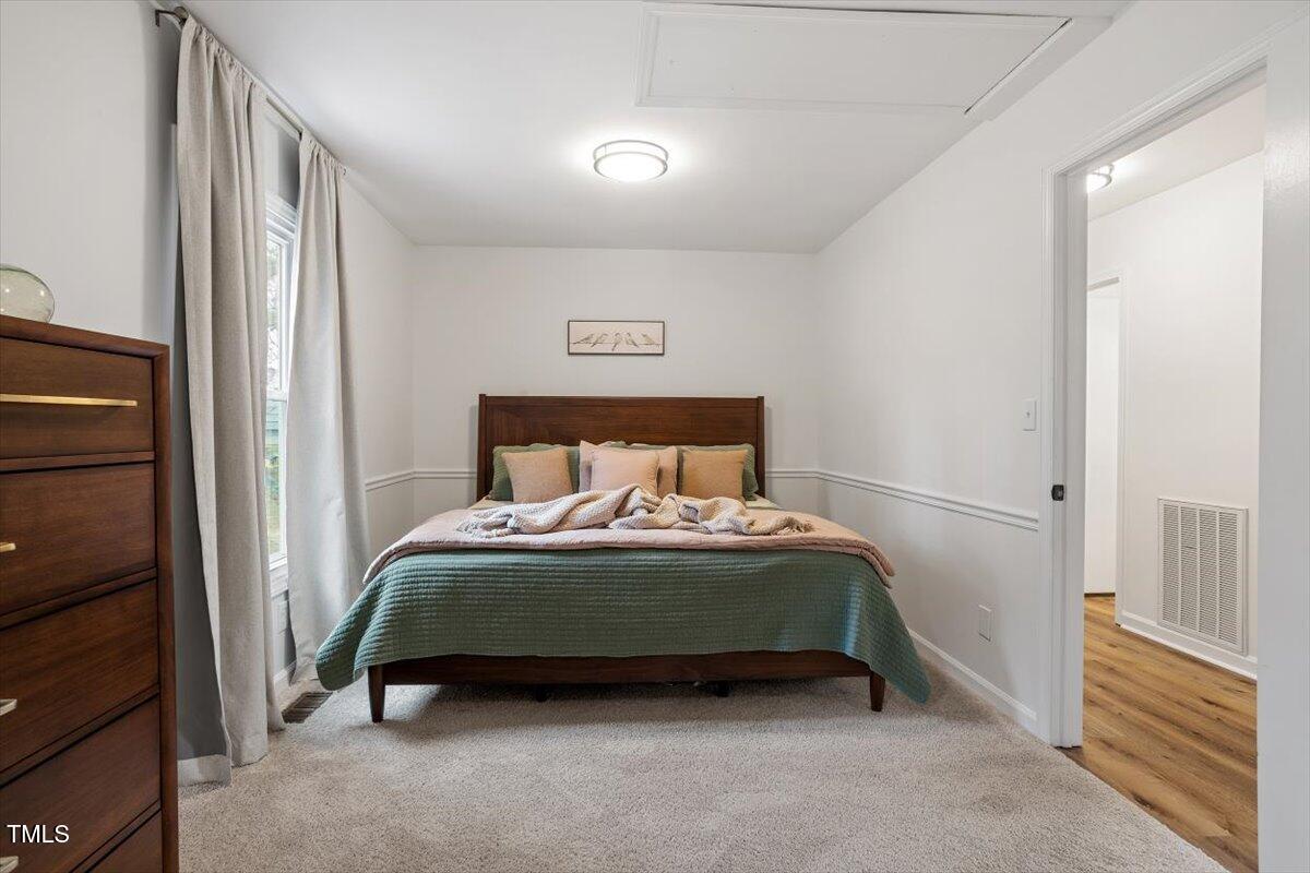 1203 Brookgreen Drive Cary, NC 27511 - Photo 17 of 46 a bedroom with a bed and a window