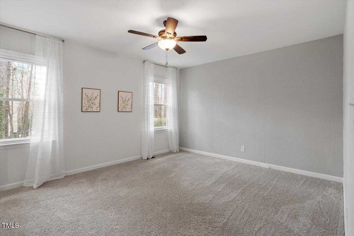 1203 Brookgreen Drive Cary, NC 27511 - Photo 20 of 46 an empty room with windows and fan