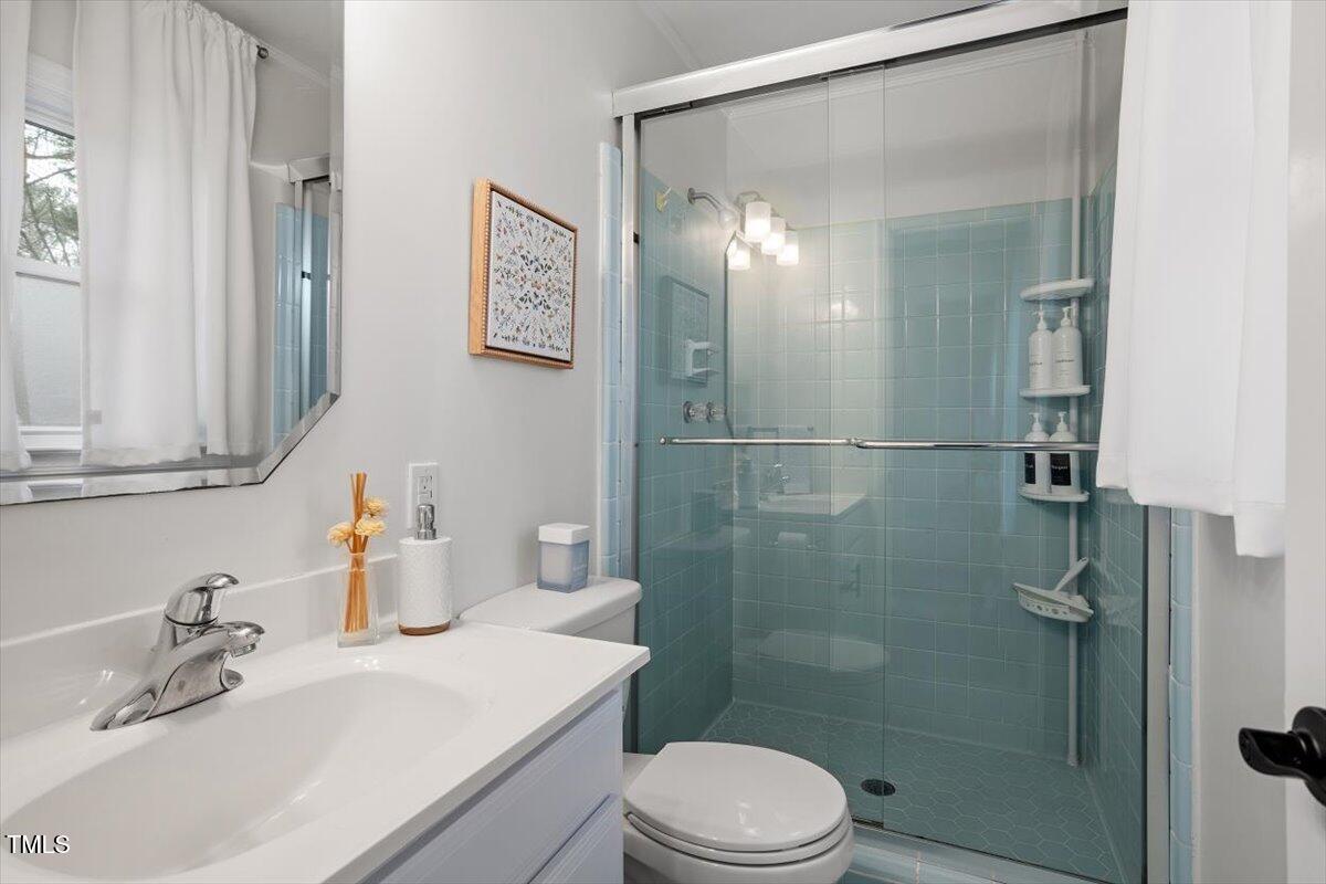 1203 Brookgreen Drive Cary, NC 27511 - Photo 22 of 46 a bathroom with a sink toilet and shower