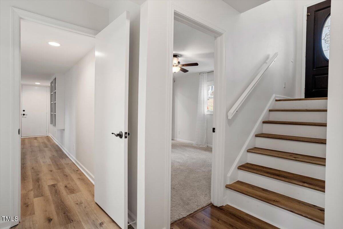1203 Brookgreen Drive Cary, NC 27511 - Photo 23 of 46 a view of entryway with wooden floor and staircase
