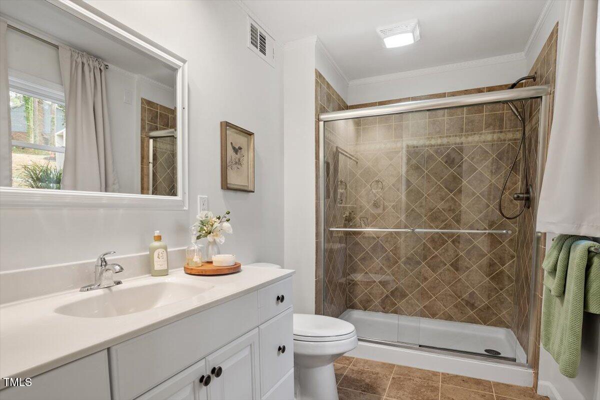 1203 Brookgreen Drive Cary, NC 27511 - Photo 25 of 46 a bathroom with a sink toilet and shower