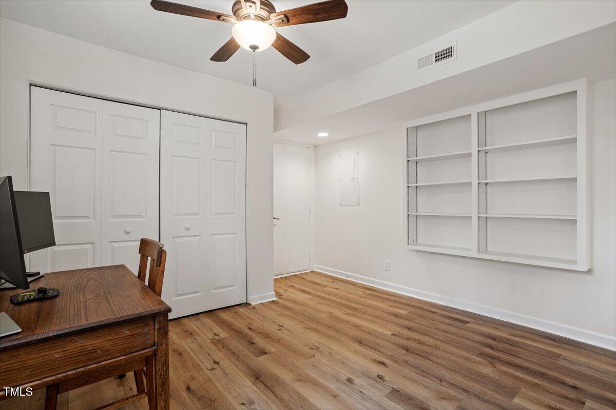 1203 Brookgreen Drive Cary, NC 27511 - Photo 26 of 46 a bedroom with a bed and a chandelier