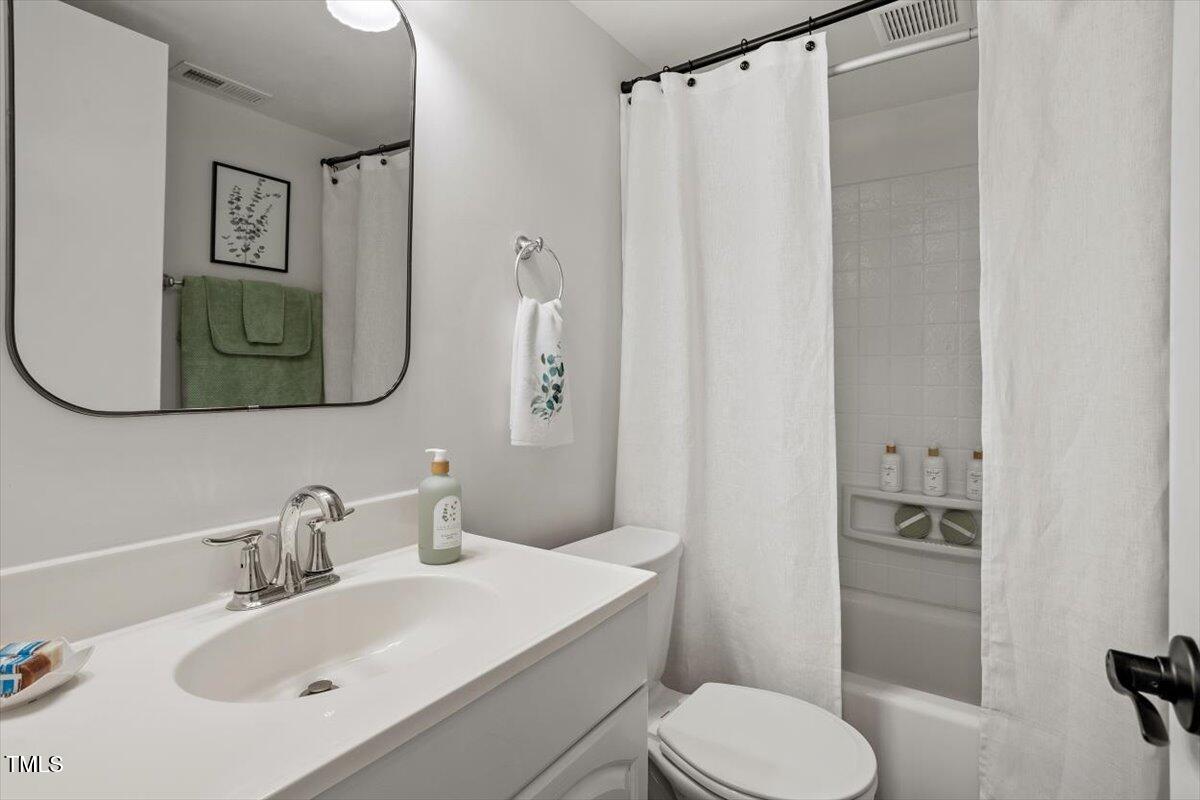 1203 Brookgreen Drive Cary, NC 27511 - Photo 28 of 46 a bathroom with a sink toilet and mirror