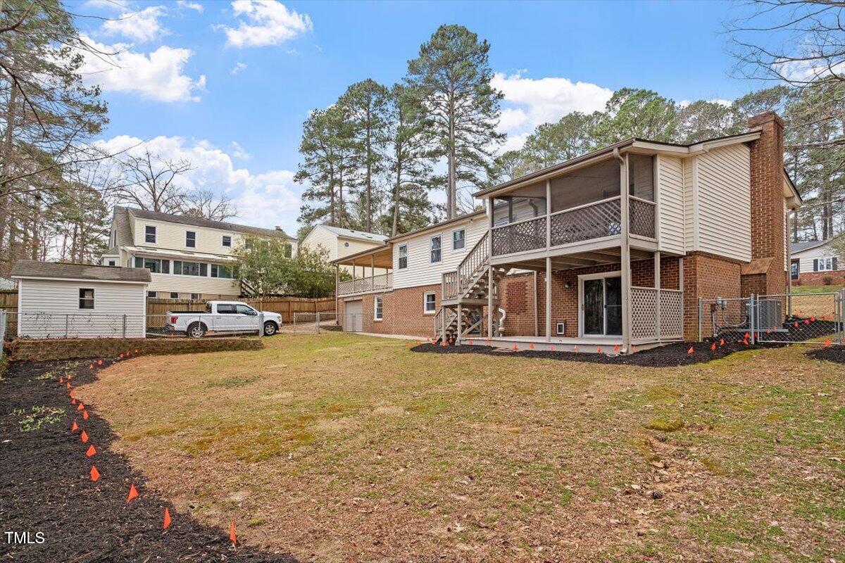 1203 Brookgreen Drive Cary, NC 27511 - Photo 42 of 46 a view of a house with a yard covered with snow in the background