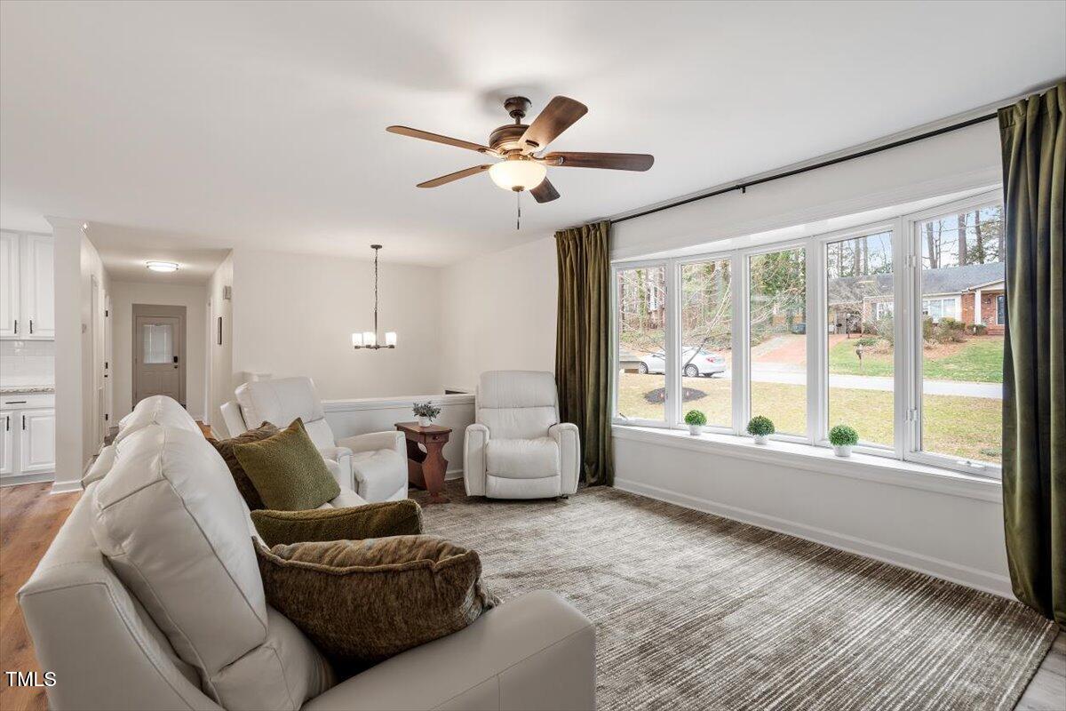 1203 Brookgreen Drive Cary, NC 27511 - Photo 6 of 46 a living room with furniture and a large window with kitchen view