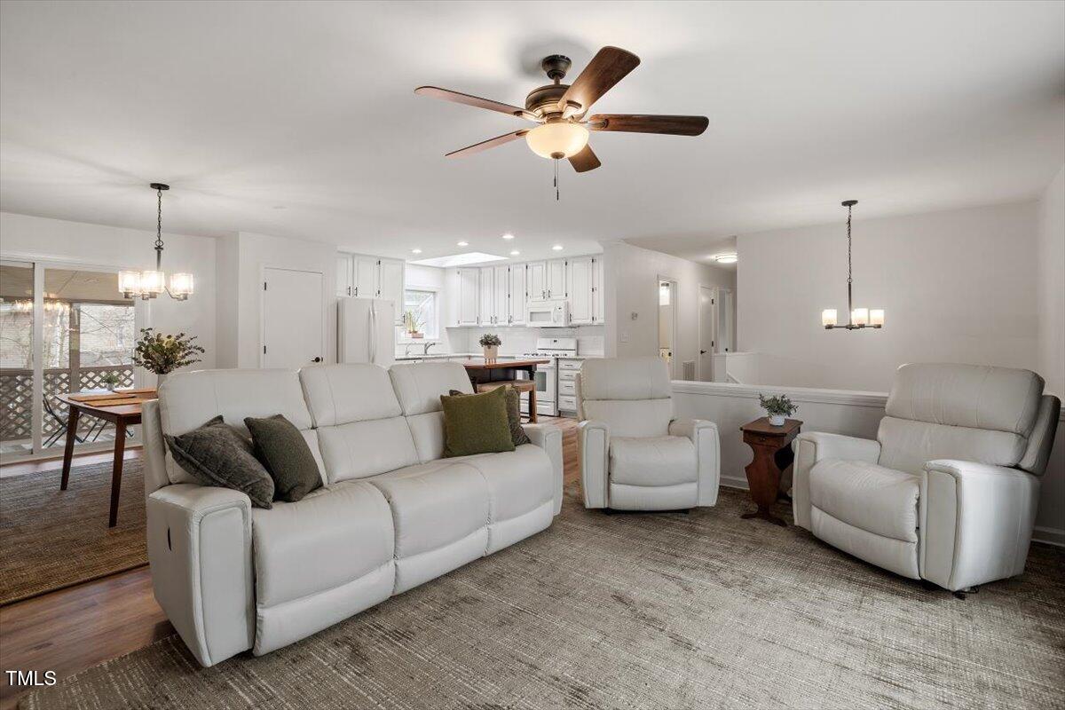 1203 Brookgreen Drive Cary, NC 27511 - Photo 8 of 46 a living room with furniture and a chandelier