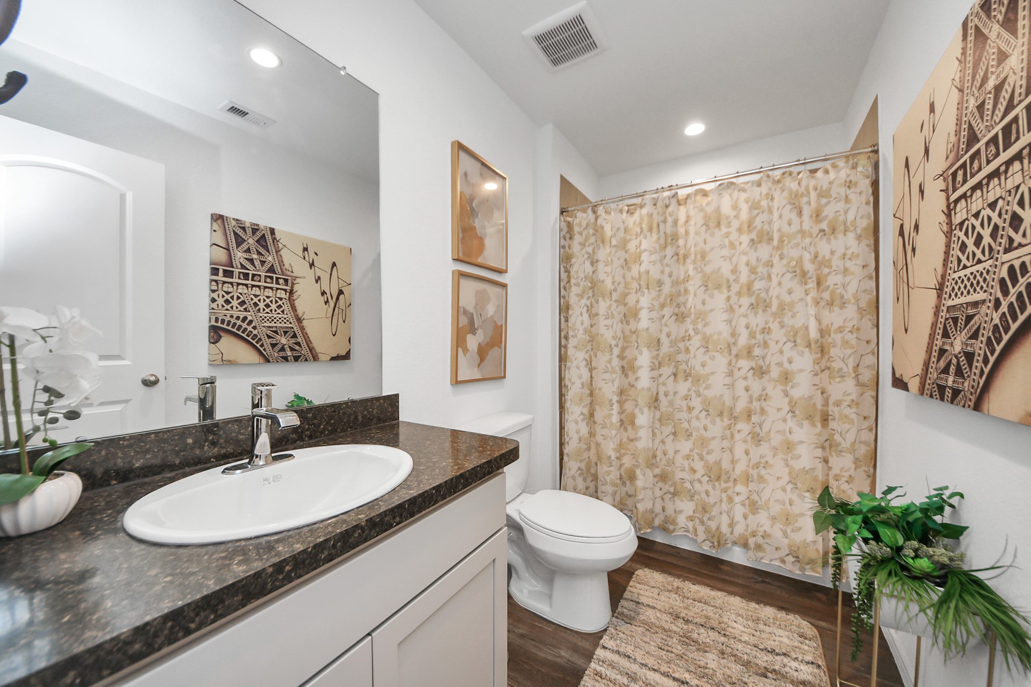 5715 Aspen Acres Drive Spring, TX 77373 - Photo 19 of 24 a bathroom with a granite countertop sink a toilet a mirror and shower curtain