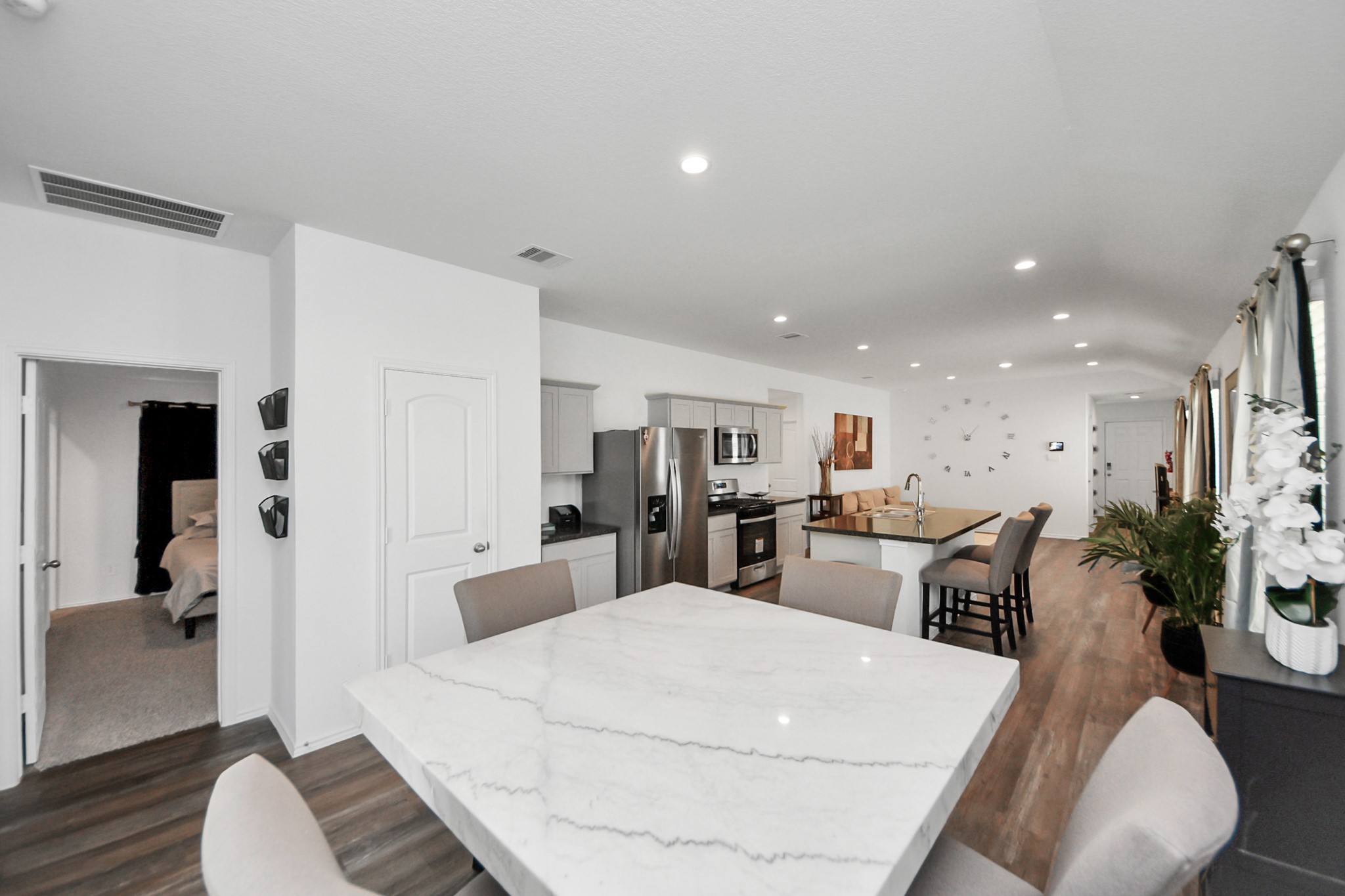 5715 Aspen Acres Drive Spring, TX 77373 - Photo 6 of 24 a large room with kitchen island a stove a table and chair