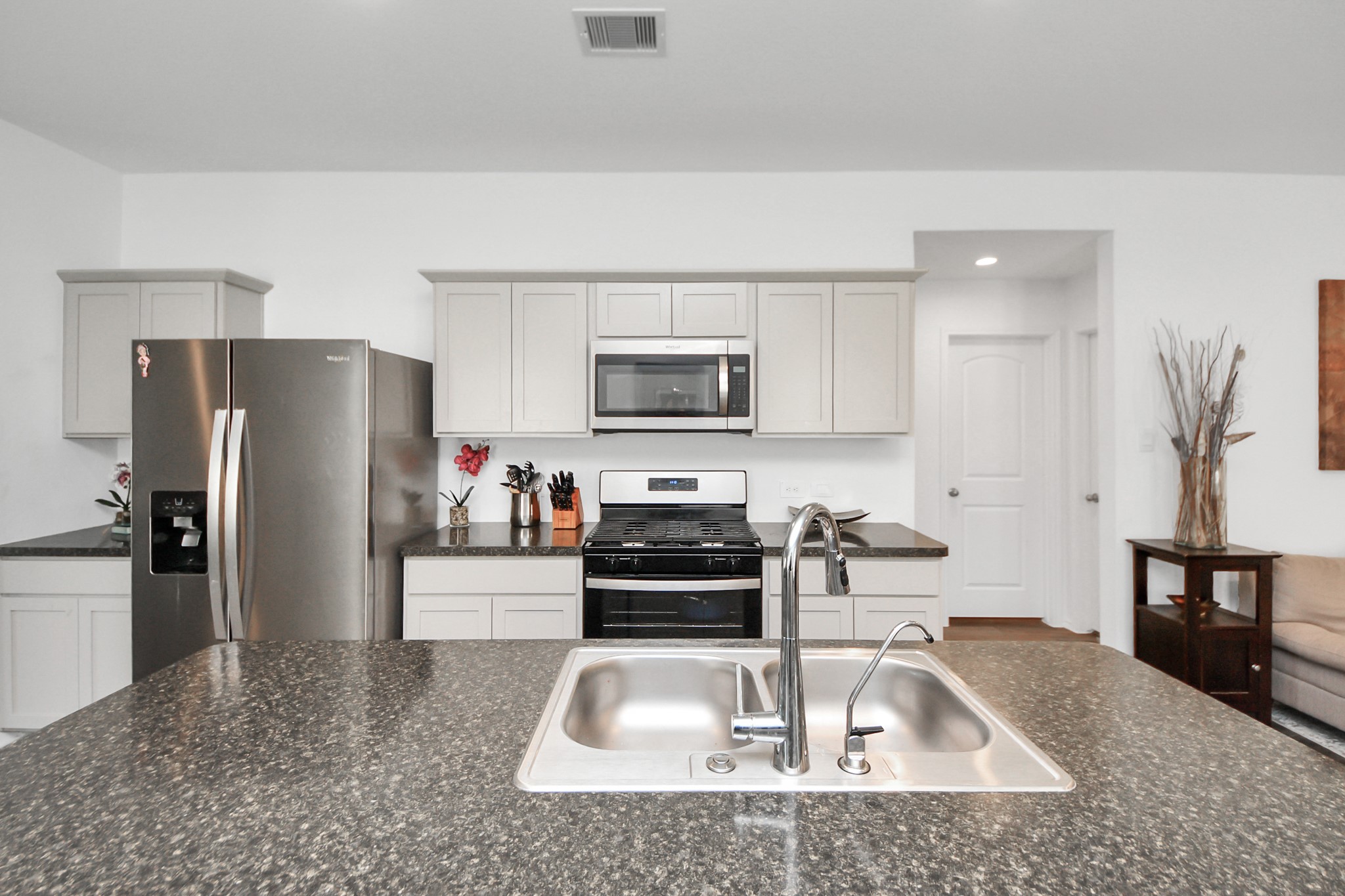 5715 Aspen Acres Drive Spring, TX 77373 - Photo 7 of 24 a kitchen with a sink a refrigerator and a stove top oven