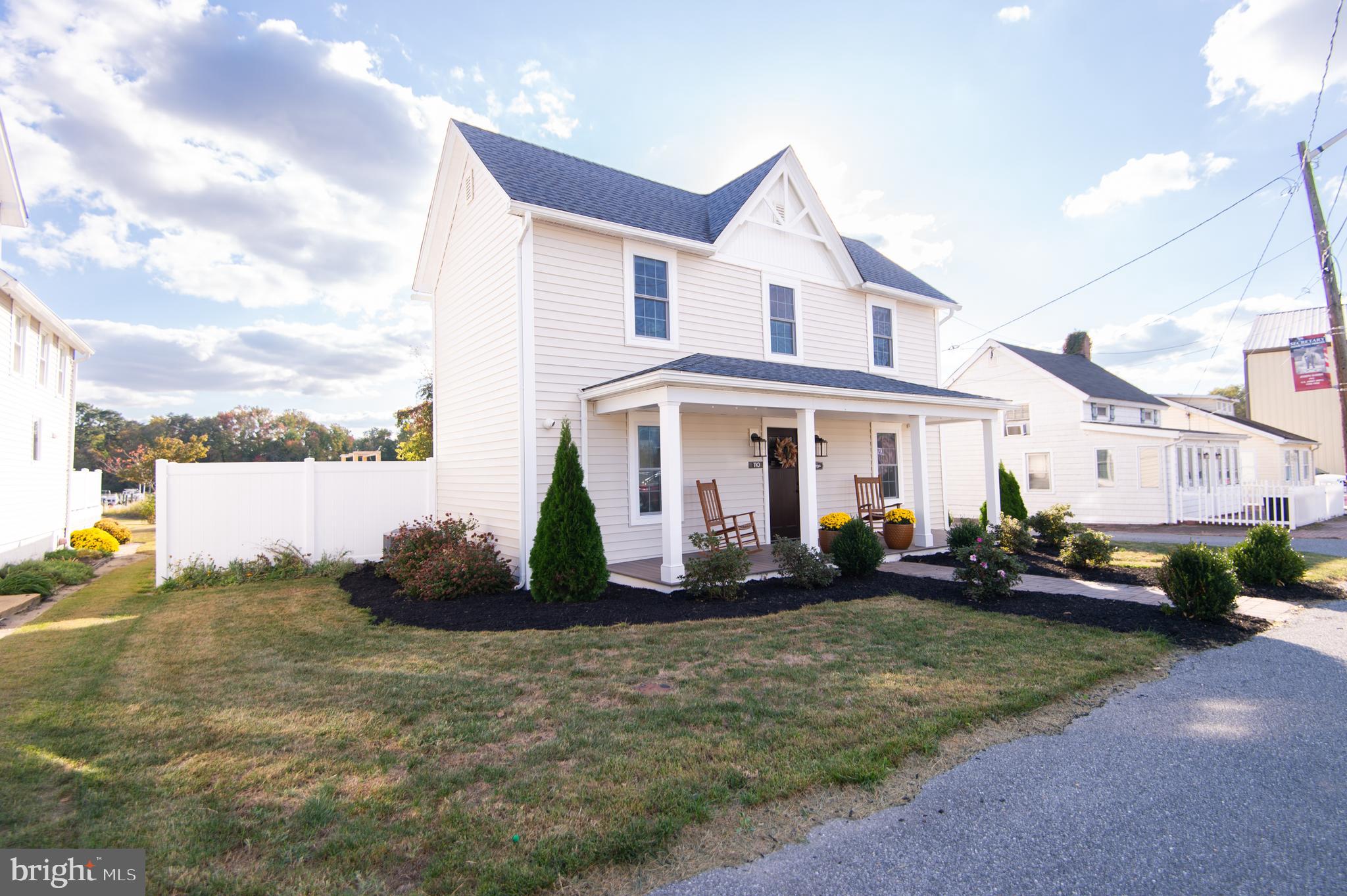 110 Second Street Secretary, MD 21664 - Photo 4 of 36 a view of a white house with large windows next to a road