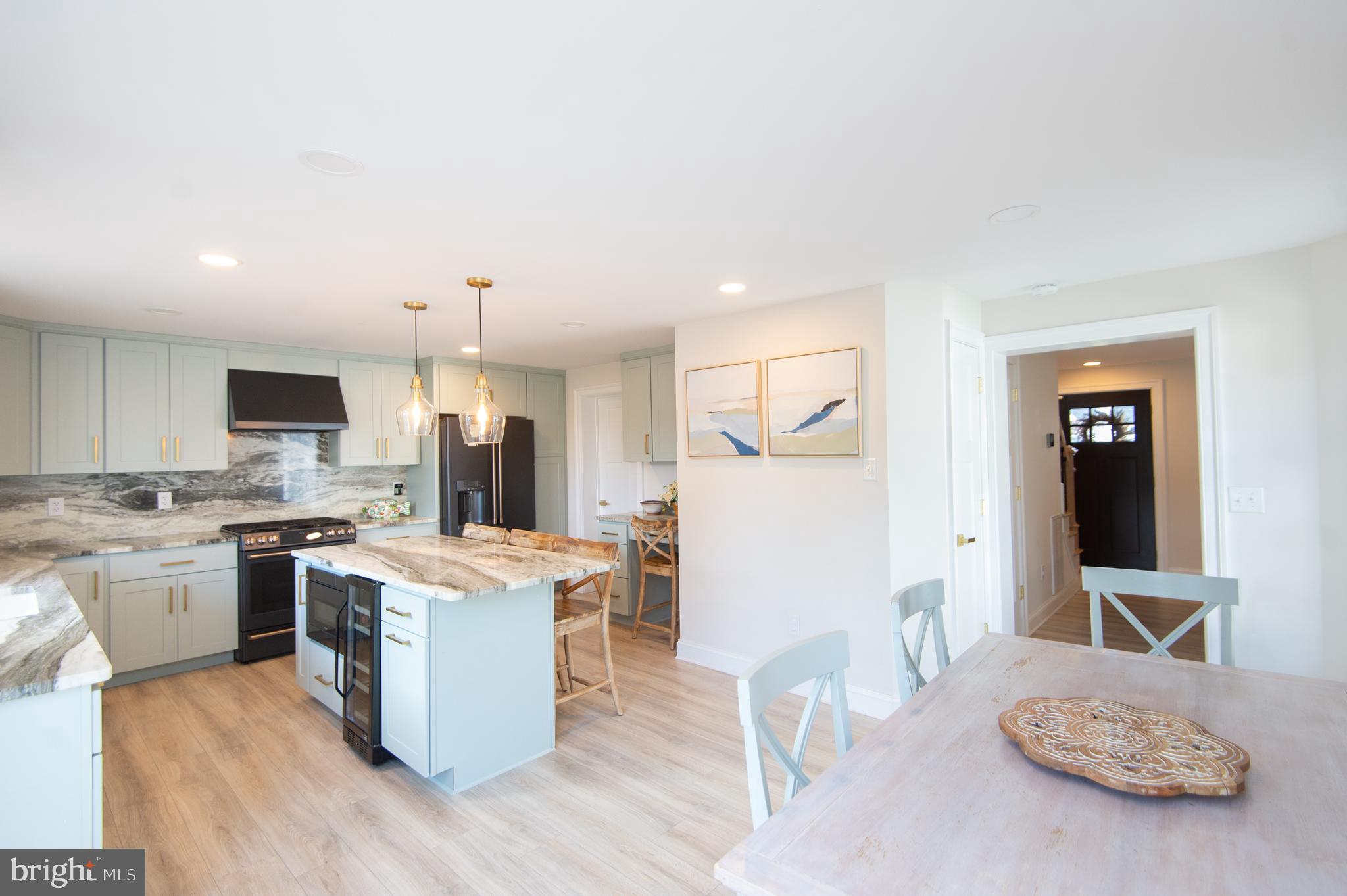 110 Second Street Secretary, MD 21664 - Photo 7 of 36 a open kitchen with stainless steel appliances granite countertop a stove top oven a sink dishwasher and a refrigerator with wooden floor