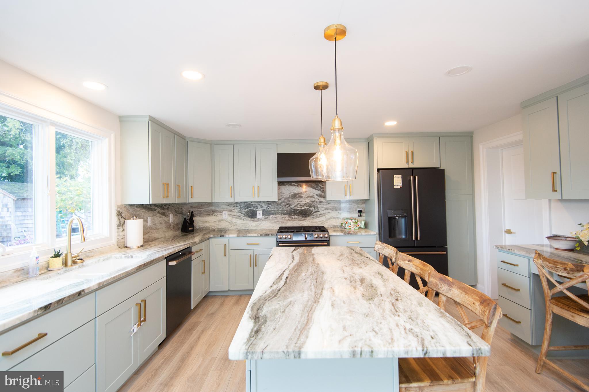 110 Second Street Secretary, MD 21664 - Photo 8 of 36 a kitchen with stainless steel appliances granite countertop a sink stove and refrigerator