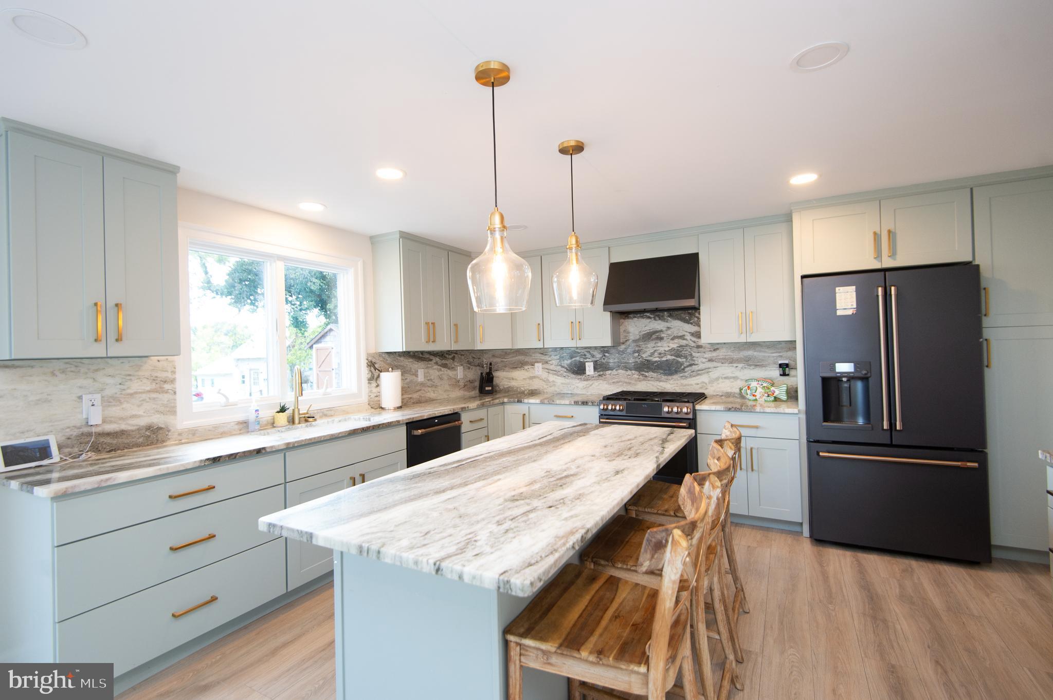 110 Second Street Secretary, MD 21664 - Photo 9 of 36 a kitchen with granite countertop a sink appliances cabinets and counter space