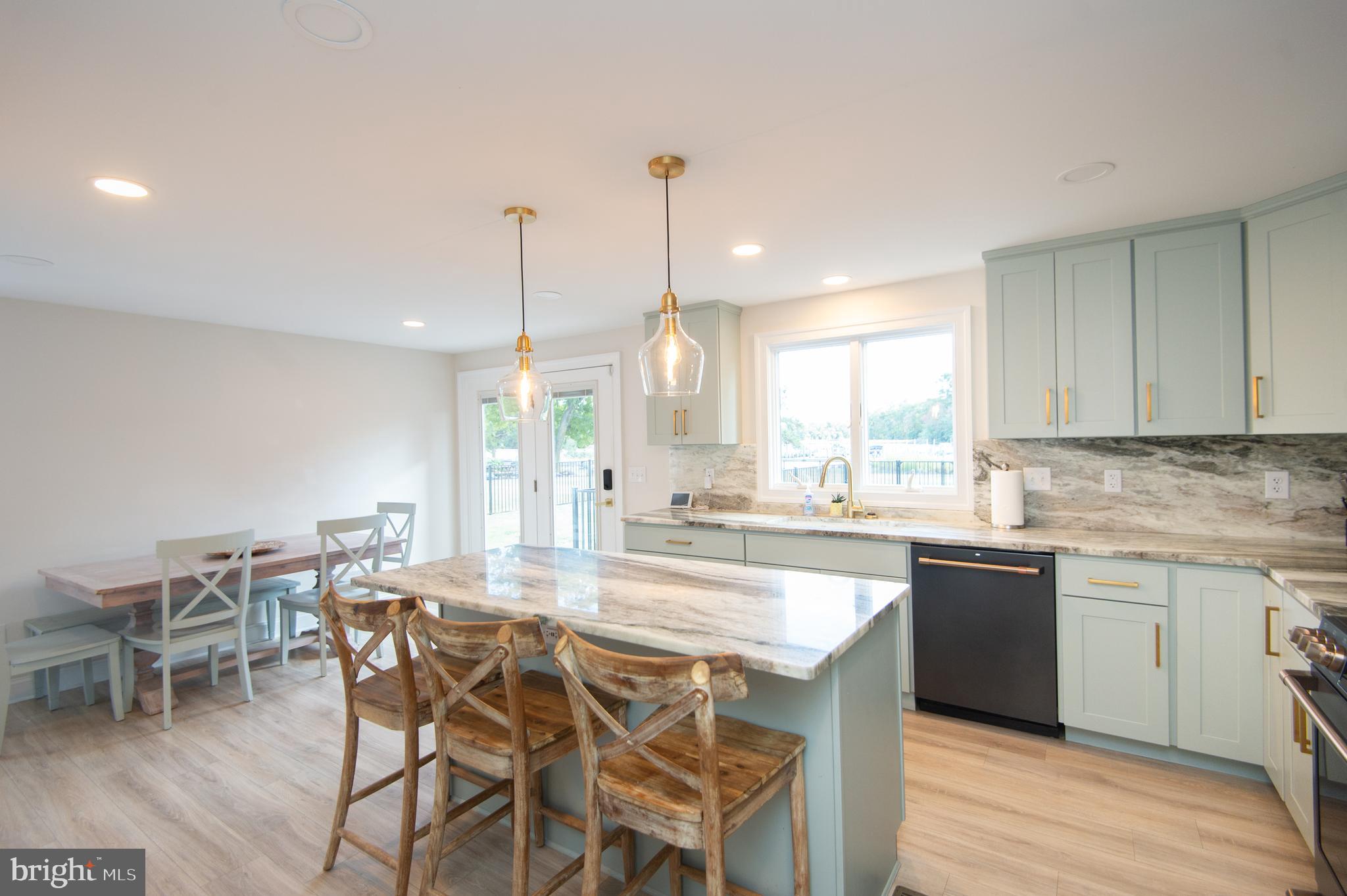 110 Second Street Secretary, MD 21664 - Photo 10 of 36 a kitchen with a dining table chairs sink and cabinets