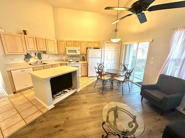a living room with furniture a rug and white walls