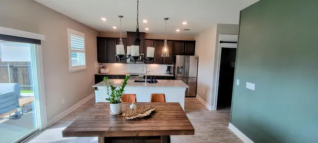 a kitchen with kitchen island white cabinets and stainless steel appliances