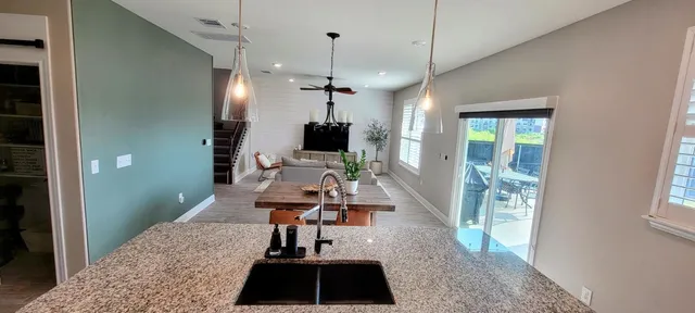 a very nice looking room with a large window and chandelier