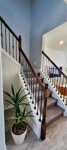 a view of entryway with wooden floor and stairs