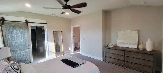 a bedroom with a bed and a mirror