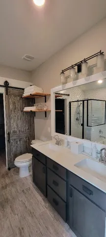 a bathroom with a sink toilet and shower