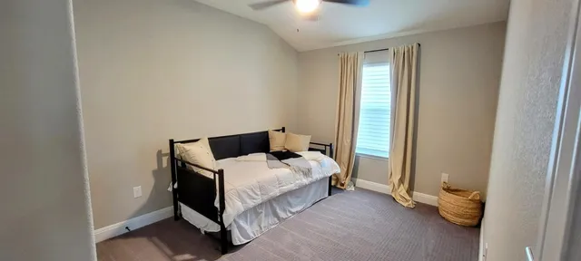 a bedroom with a bed and window