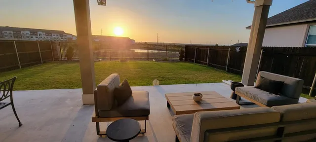 a view of a garden with furniture