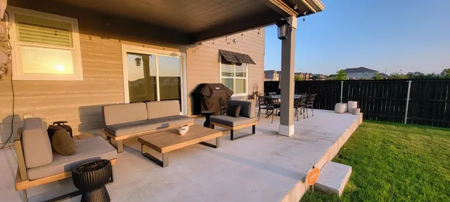 a view of a patio with a table and chairs