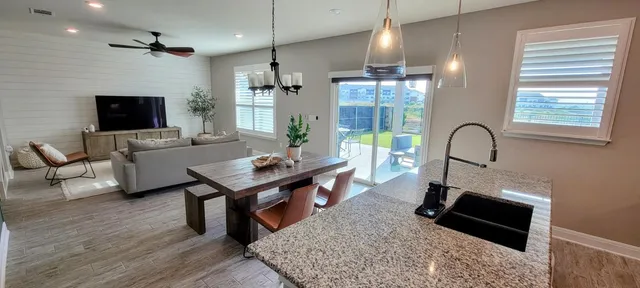 a living room with furniture a rug and a chandelier