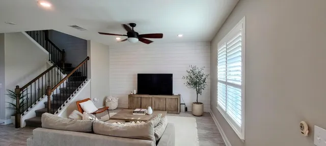 a living room with furniture tv and a fireplace