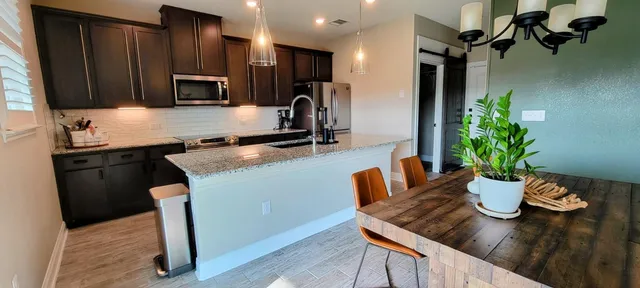 a kitchen with a table and chairs in it