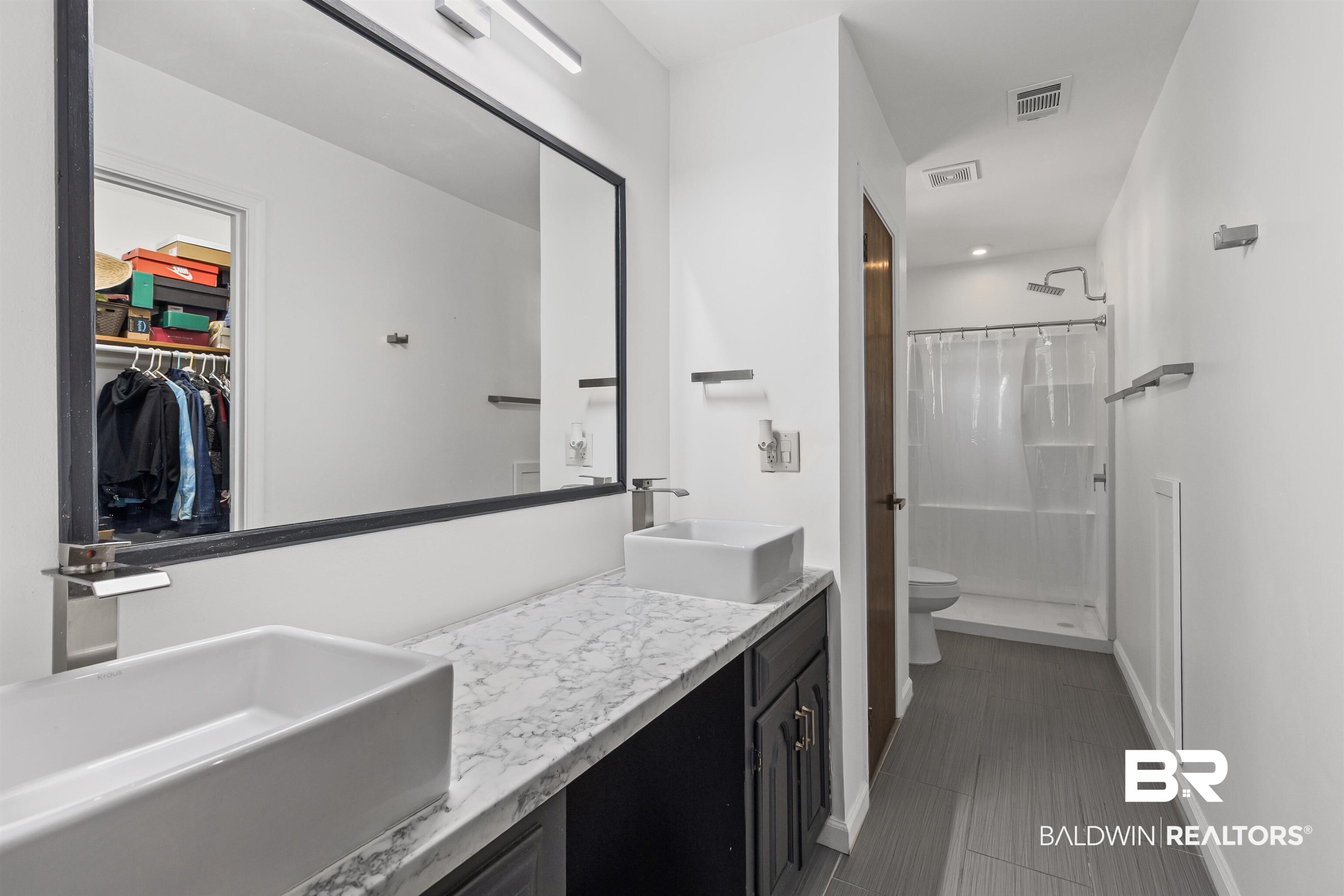 8911 Owassa Road Evergreen, AL 36401 - Photo 14 of 24 Bathroom featuring a stall shower, double vanity, and a spacious closet