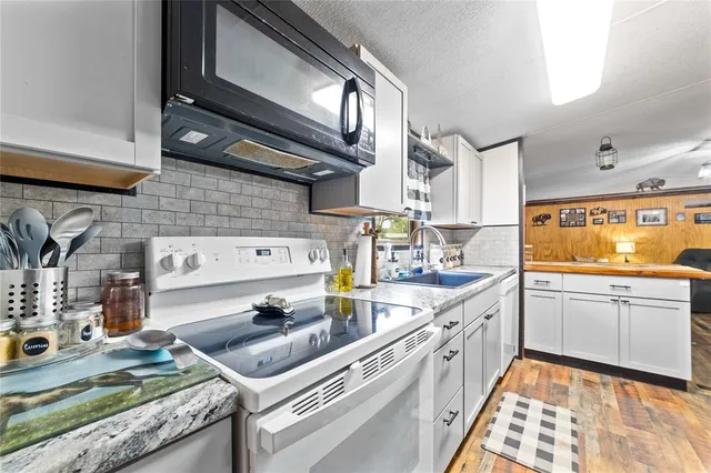 a bathroom with a double vanity sink toilet mirror and shower