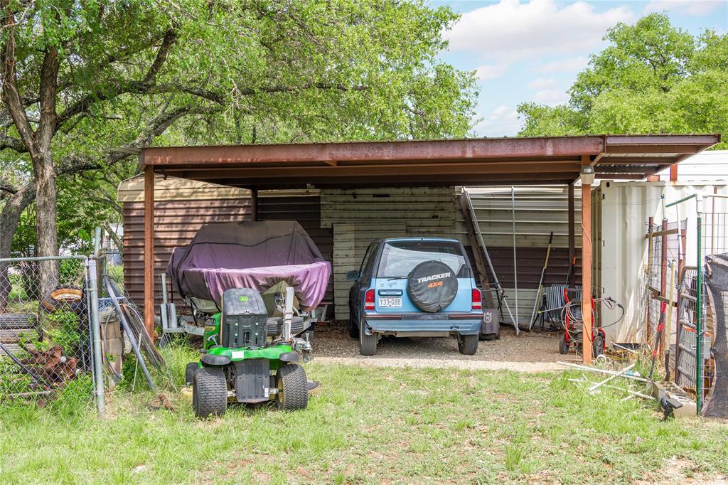 4991 Thunderbird Drive May, TX 76857 - Photo 25 of 34 View of outdoor structure with fence and a carport