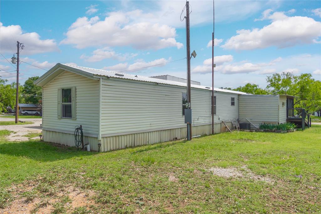 4991 Thunderbird Drive May, TX 76857 - Photo 27 of 34 View of property exterior featuring a yard