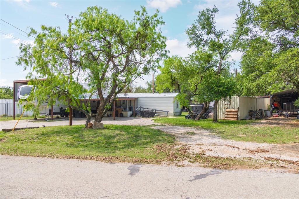 4991 Thunderbird Drive May, TX 76857 - Photo 30 of 34 View of front of house featuring a front lawn and fence