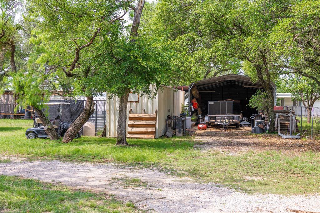 4991 Thunderbird Drive May, TX 76857 - Photo 31 of 34 View of pole building featuring fence and a detached carport