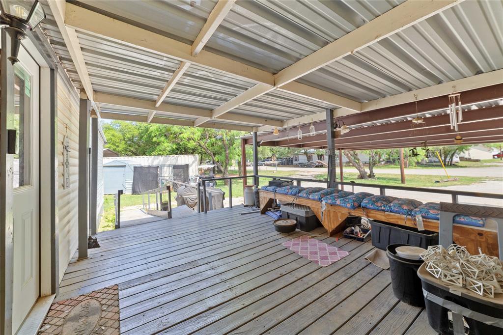 4991 Thunderbird Drive May, TX 76857 - Photo 5 of 34 Wooden deck featuring an outbuilding and a storage shed