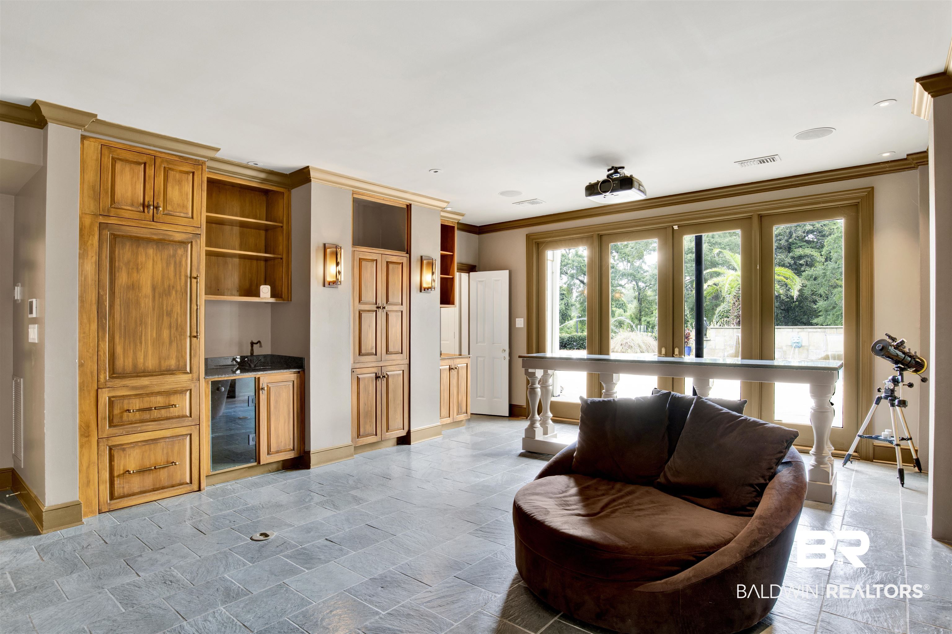 3816 Austill Lane Mobile, AL 36608 - Photo 48 of 80 Living area featuring ornamental molding, wet bar, wine cooler, and stone finish floors